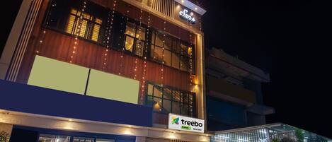 A two-story building with a 'treebo' sign, indicating a restaurant or cafe.