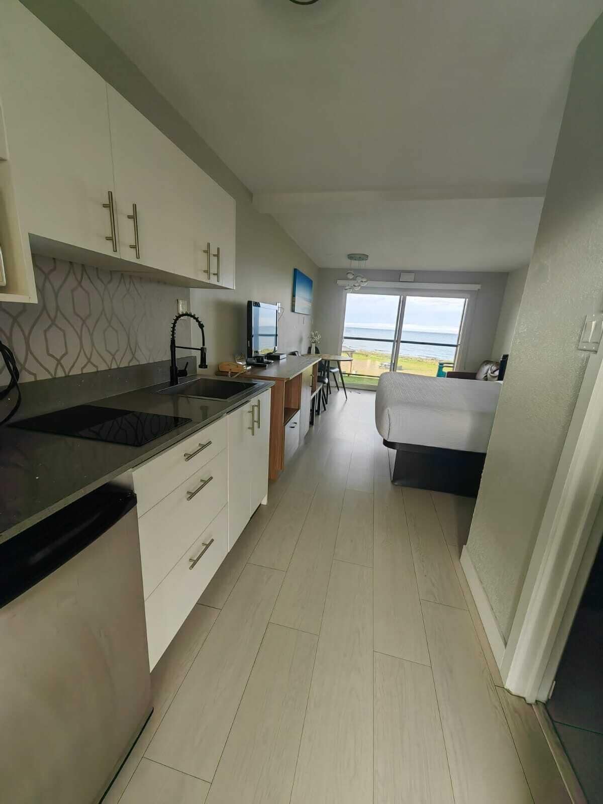 Oceanview King Room w/ Kitchenette | Desk, laptop workspace, blackout drapes, iron/ironing board