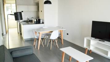 Deluxe Apartment, 1 Bedroom | Living area | 32-inch Smart TV with cable channels, TV, Netflix