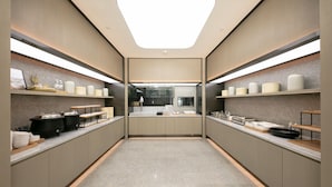 A modern kitchen with a central island, built-in appliances, and ample storage space. - JI Hotel (Beijing)