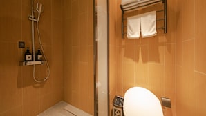 A bathroom with a shower, toilet, and towel rack. - JI Hotel (Beijing)