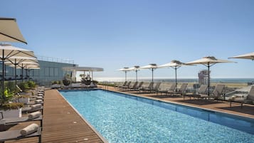 Seasonal outdoor pool, open 10:00 AM to 6:00 PM, pool umbrellas