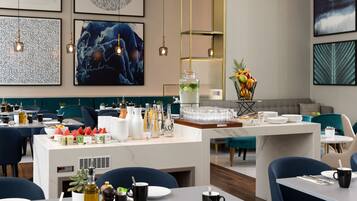 A modern restaurant with a central island, dining tables, and chairs.