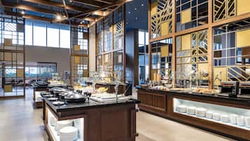 A spacious buffet area with a variety of food options and a seating area with tables and chairs.