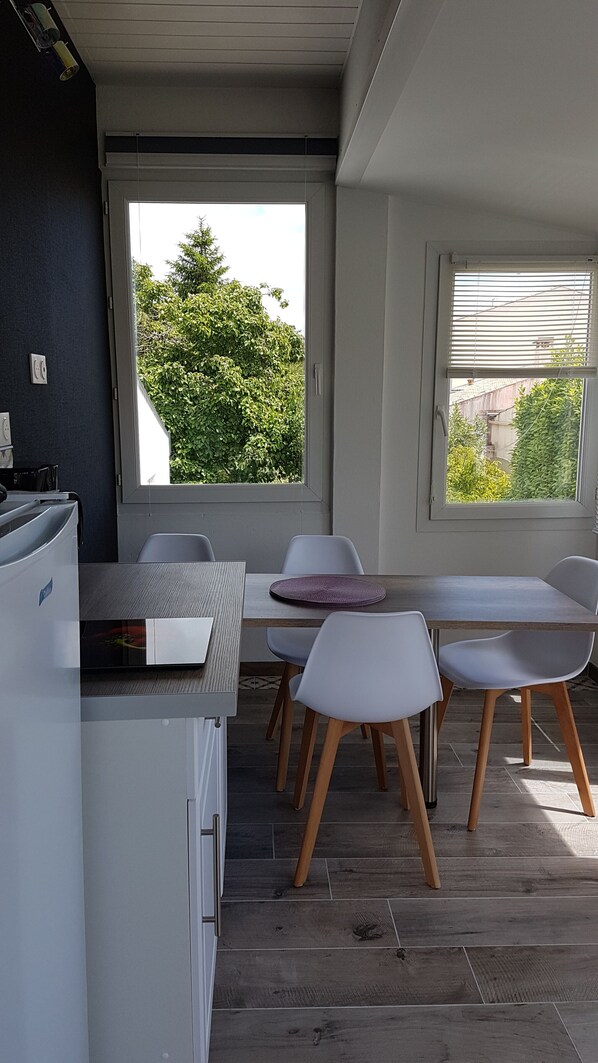 A modern kitchen with a dining area.