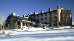 A large building with multiple windows and a snow-covered ground. - King Bed Condo at Cedar Breaks Lodge (Brian Head)