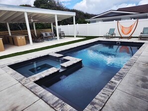 A rectangular swimming pool with steps leading into it, surrounded by a concrete deck. - Ocean Views and Private Pool: Classic 1950’s Beach Gem (Fernandina Beach)