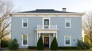 A two-story house with a front porch, a balcony, and a symmetrical window arrangement. - Cozy, and private apartment near Lake Shelbyville (Shelbyville)