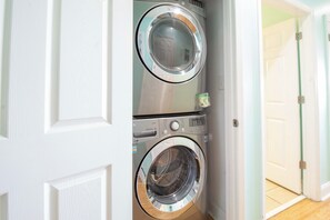 A laundry room with two stacked front-loading washing machines.
