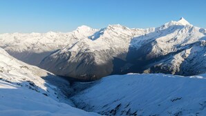 A snow-covered mountain landscape with rugged terrain and a valley. - Exclusive Alpine Chalet overlooking Mt Aspiring National Park (Wanaka)