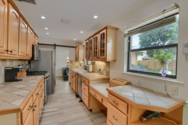 Enjoy cooking in this well-equipped kitchen with a refrigerator, oven, and gas stove.