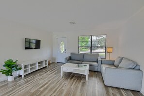 Relax in this stylish living room with a comfortable sofa, flat-screen TV, and a beautiful view.