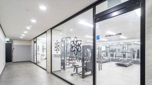 A fitness gym with glass walls, exercise equipment, and a clean, modern interior. - Cheonan DRAPA Hotel (Cheonan)