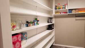 A kitchen with white cabinets, shelves with various kitchen items, and a coffee maker. - Clean and spacious house in downtown Fayetteville (Fayetteville)