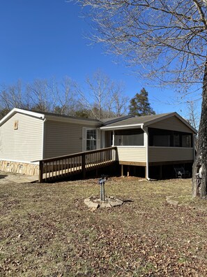 A single-story house with a covered porch and a detached garage.