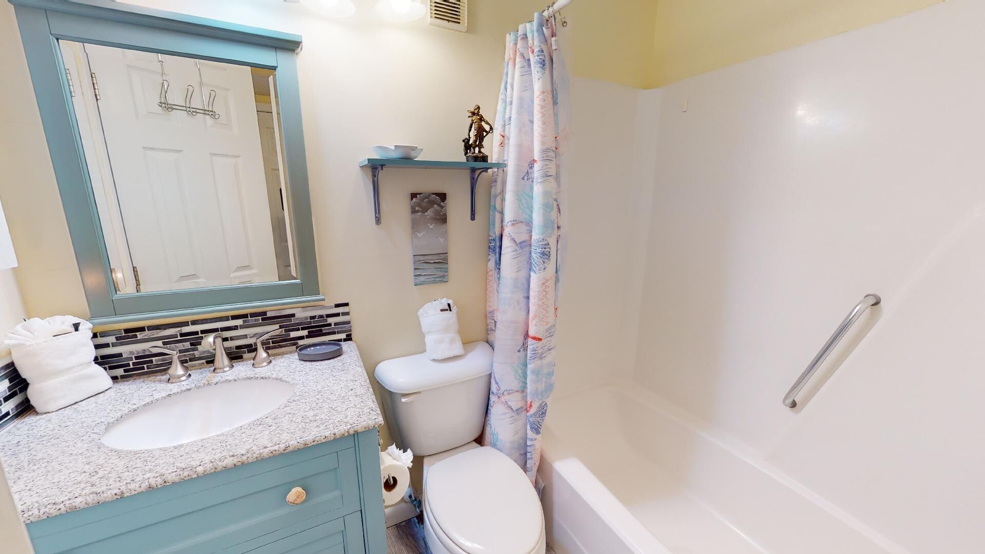 A bathroom with a sink, toilet, and bathtub.