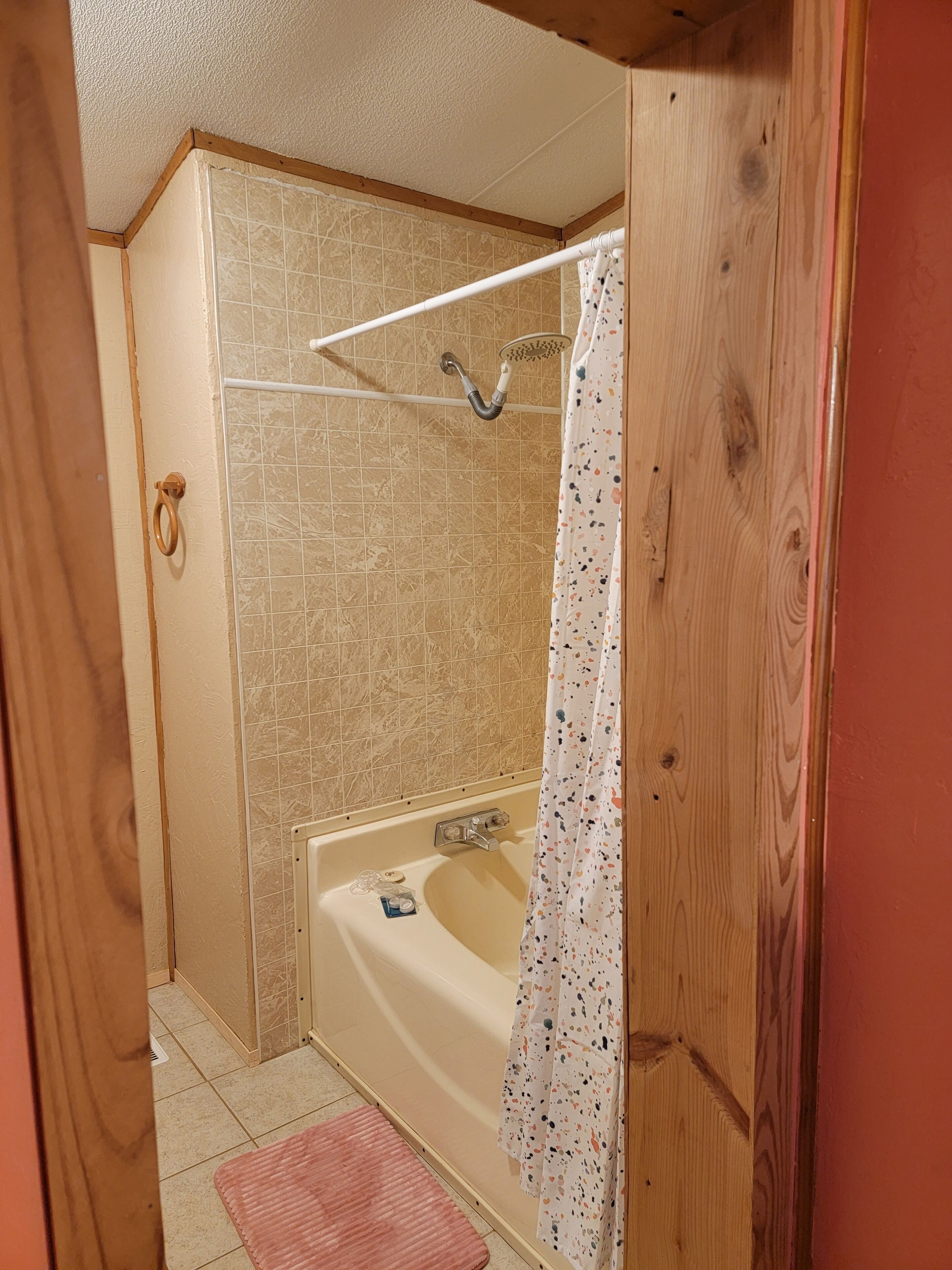 A bathroom with a shower, a bathtub, and a toilet.