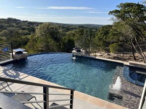 A swimming pool with a view of a forested landscape. - Rare Find: Secluded Hillside Views w Swimming Pool (Canyon Lake)
