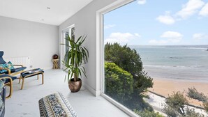 A modern living room with a large window overlooking a beach. - De'nada, Vernon Court -  an apartment that sleeps 2 guests  in 1 bedroom (Torquay)
