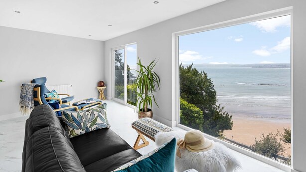 A spacious living room with a large window overlooking a beach. - De'nada, Vernon Court -  an apartment that sleeps 2 guests  in 1 bedroom (Torquay)