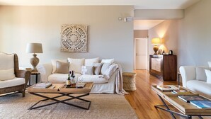 A modern living room with a sofa, coffee table, and a decorative wall piece. - Luxurious villa on the Etna slopes, with private pool and fitness area (Viagrande)