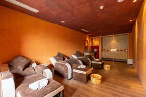A spa room with multiple massage chairs, wooden flooring, and a reception area with a window. - Sala Grand Tuy Hoa Hotel (Tuy Hoa)