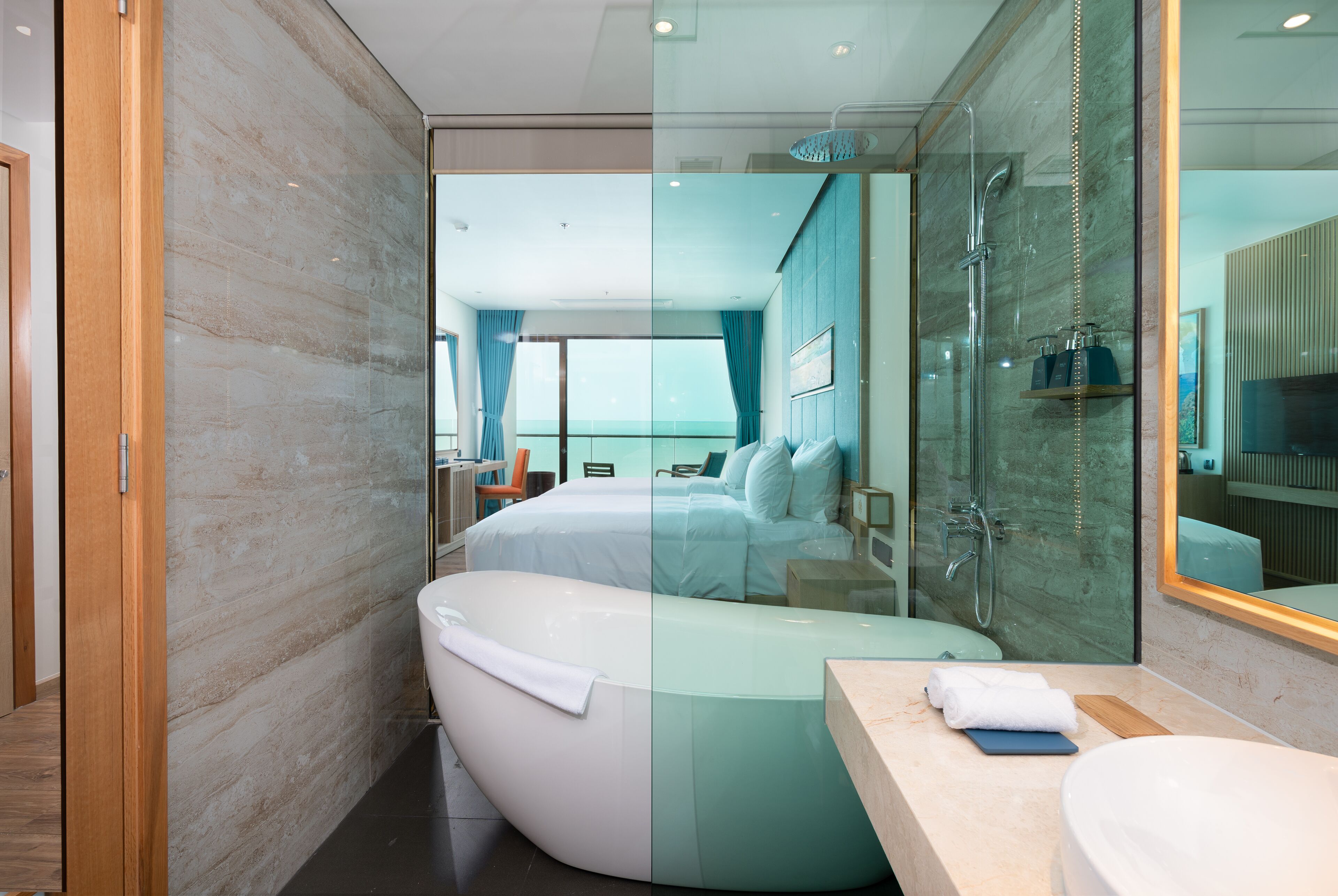 A modern bathroom with a freestanding bathtub, a glass-enclosed shower, and a large mirror.