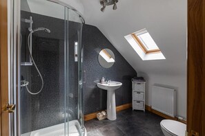 Bathtub, hair dryer, towels, toilet paper