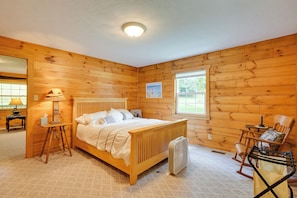 Relax in this serene bedroom with a single bed, bedside table, and comfortable rocking chair.