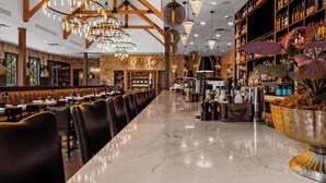 A long, polished marble bar with leather booths and a high ceiling with exposed beams and chandeliers. - 30A ☀️ 6 Seat Golf Cart | *Heated & Chilled Pool | Gated | Beach Equip ☀️Near Restaurants (Santa Rosa Beach)