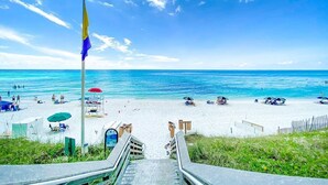 A beach with a flagpole, a staircase leading to the beach, and a clear blue sky. - 30A ☀️ 6 Seat Golf Cart | *Heated & Chilled Pool | Gated | Beach Equip ☀️Near Restaurants (Santa Rosa Beach)
