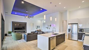 A modern kitchen with a central island, built-in appliances, and pendant lighting. - Private Pool: Canalfront Home in Cape Coral (Cape Coral)