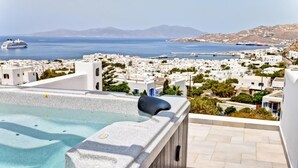 A rooftop pool with a clear view of a coastal town and the sea. - Ibiscus Boutique Hotel (Mykonos)