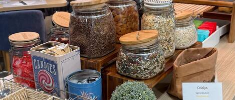 A food display with various jars of nuts, seeds, and candies.
