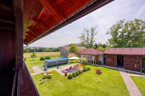 A residential property with a swimming pool, outdoor seating, and a view of the countryside. - Merry's House w/ Pool & Sauna (Črnomelj)