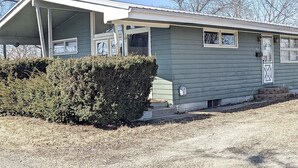 A small, single-story house with a covered porch and a small front yard. - Cheerful 3 BR Residential Home in Small Town USA (woodsfield)