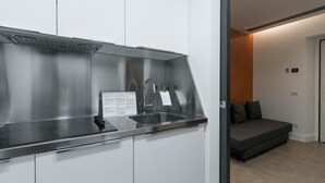A modern kitchen with a stainless steel sink, a built-in stove, and a small countertop. - Italianway Collection - Corso Venezia 7 - Tosca (Milan)