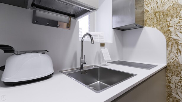 A modern kitchen with a built-in toaster, a stainless steel sink, and a range hood. - Italianway Collection - Corso Venezia 7 - Aida (Milan)
