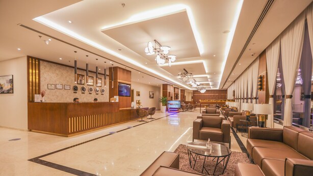 A spacious lobby with a reception desk, seating area, and modern lighting. - BW Suites & Spa (Manama)
