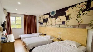 A hotel room with three beds, a wooden headboard, a desk with a lamp, and a window with curtains. - Jinhui Hotel (Guangyi Affiliated Hospital Respiratory Medicine Center Tanwei Subway Station) (Guangzhou)