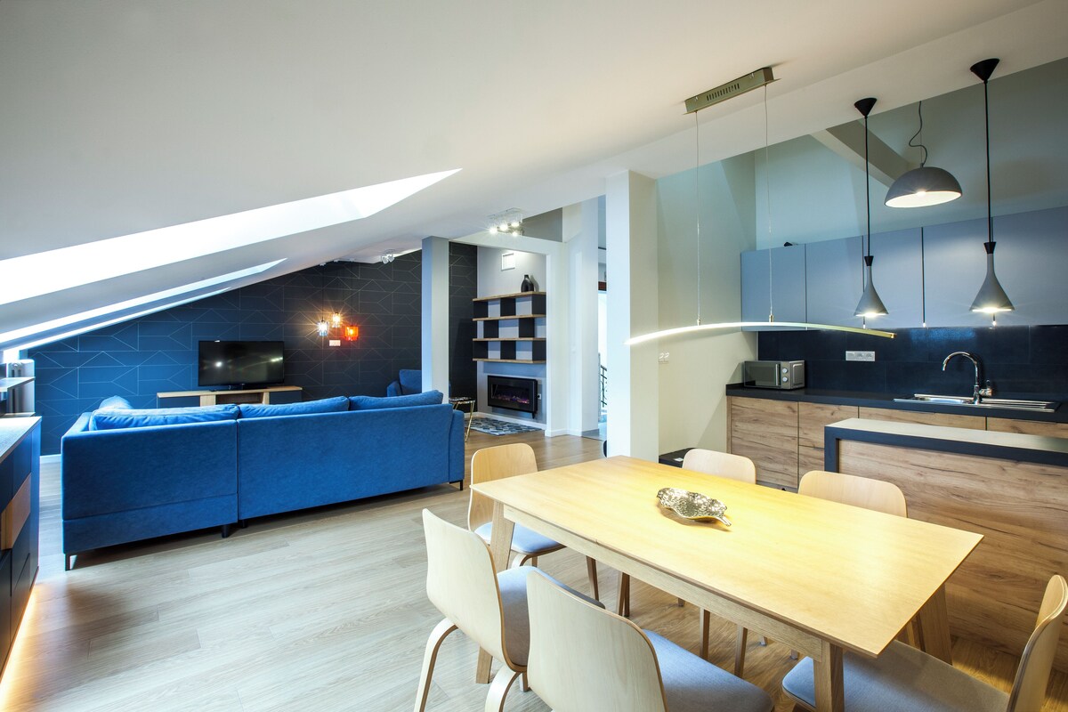A modern interior with a dining area, kitchen, and living space.