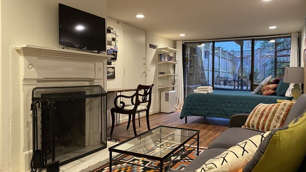 A living room with a fireplace, a sofa, a coffee table, and a TV.
