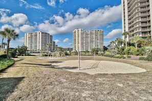 A residential area with two high-rise buildings, a playground, and well-maintained landscaping.