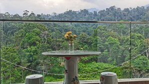A room with a large window overlooking a dense forest. - Lcp 1 (Genting Highlands)