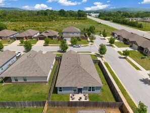 A residential area with houses, a road, and a distant mountain range.