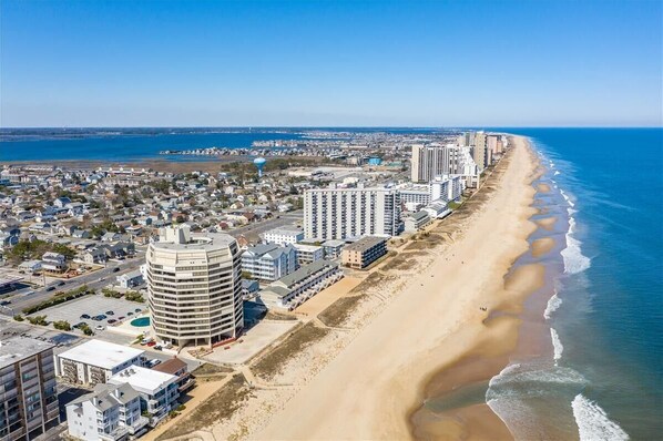 A coastal cityscape with a beachfront hotel, high-rise buildings, and a clear view of the ocean. - ** Select 2023 weeks have been discounted by $200.00! Prices shown include discount. **<br>2 br/2 bath Antigua / outdoor pool/Ofront bldg, back unit (Ocean City)