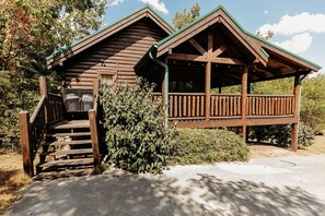 Step up to the porch and enjoy the rustic charm of this cabin-style building.