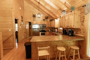 Enjoy cooking in this well-equipped kitchen with a central island and stainless steel appliances.