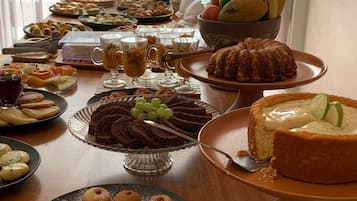 A buffet table with various desserts and fruits.
