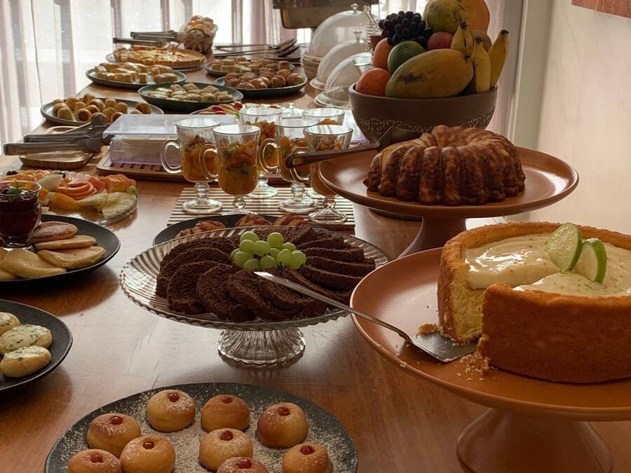 A buffet table with various desserts and fruits.